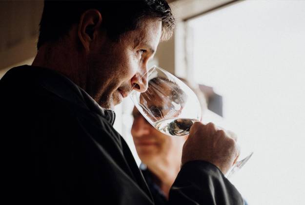 Man smelling wine from a wine glass